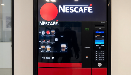 A modern Nescafe vending machine dispensing coffee