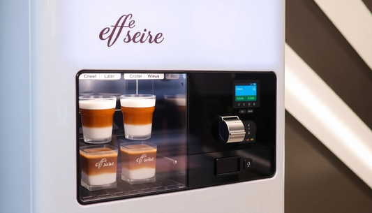 A sleek Café Desire vending machine dispensing coffee
