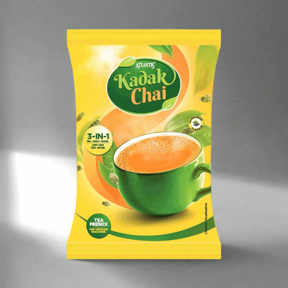Atlantis kadak tea 1kg packet with green cup of frothy chai on yellow background