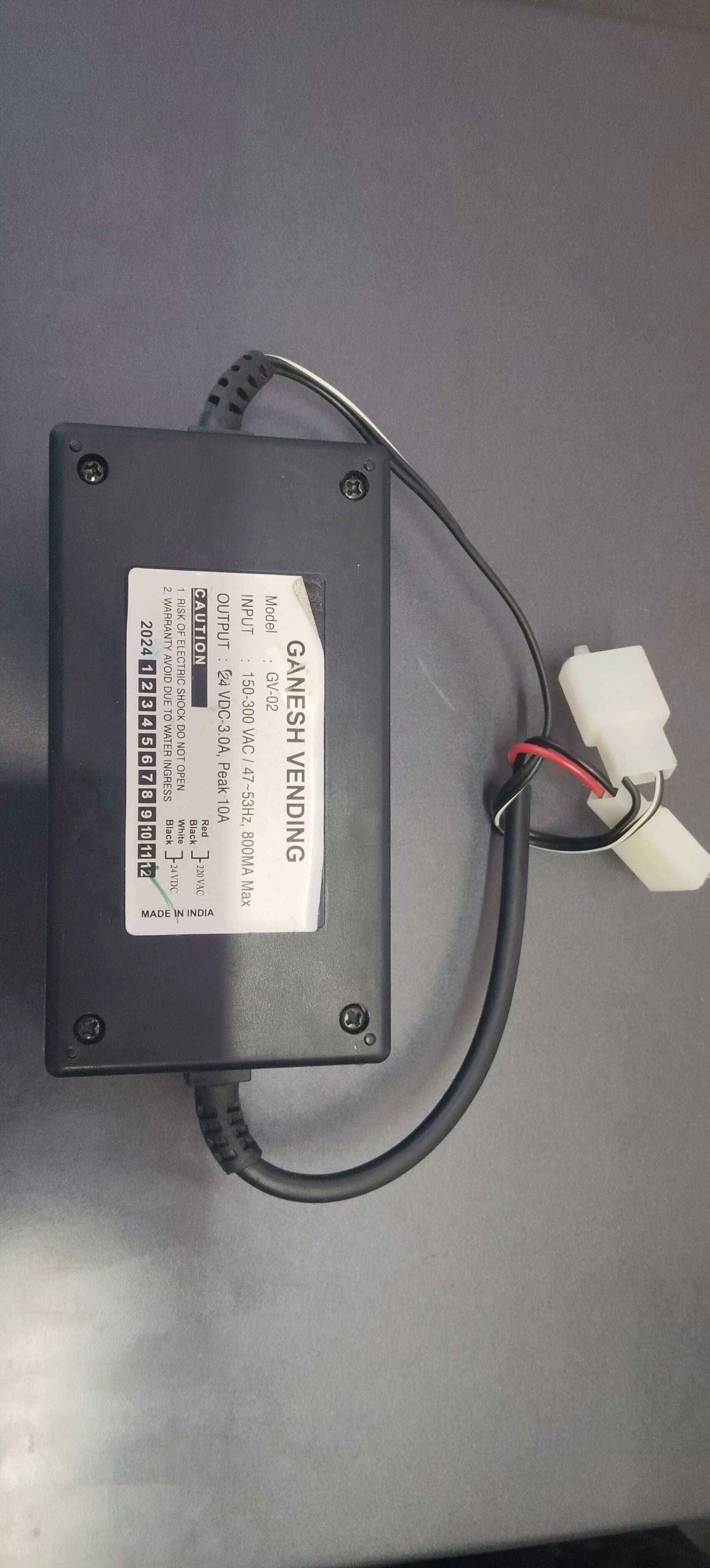Black rectangular Nescafe coffee machine adaptor with attached cables and white connectors from Tea coffee vending service
