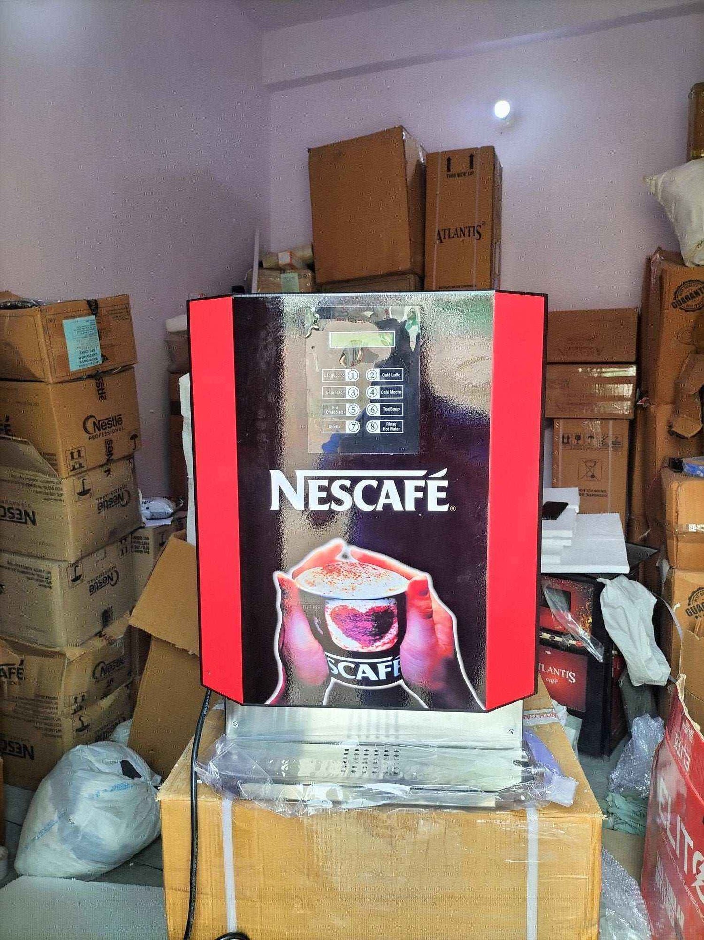 Nescafe multi option hot beverage dispenser in a storage room with cardboard boxes around