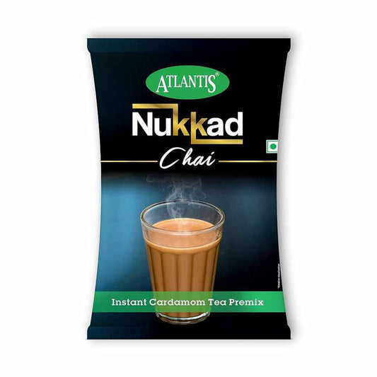 Atlantis Nukkad Tea Premix 1kg packet with instant cardamom tea mix and steaming hot tea glass