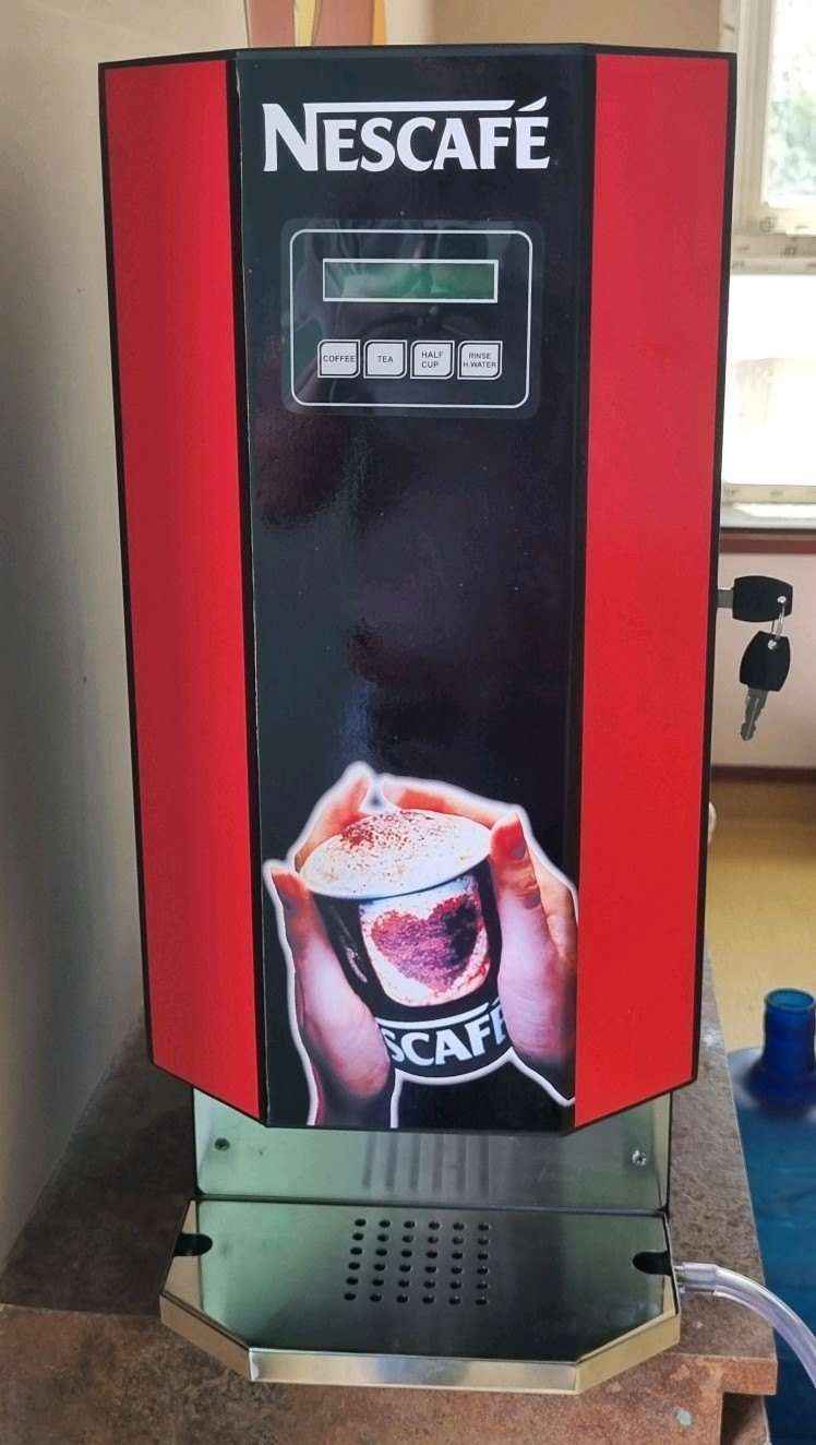 Nescafe 2 lane coffee machine in red and black with digital display and cup holder