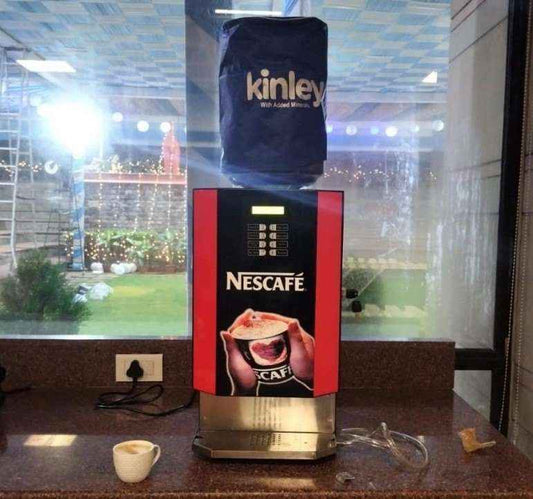 Nescafe branded automatic tea and coffee vending machine with Kinley water container on top